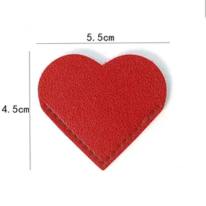 Detail view of red PU leather heart corner bookmark showing 5.5cm x 4.5cm size