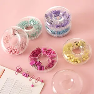 Detail view of colorful paper clips and push pins in circular transparent organizers