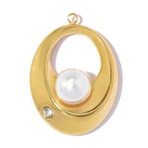 Macro view of elegant gold stainless steel pendant featuring white pearl and crystal accent
