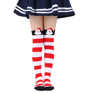 Detail view of festive red and white striped over-the-knee socks with Santa Claus doll