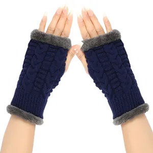 Detailed view of navy blue cable knit fingerless gloves with soft grey faux fur trim.