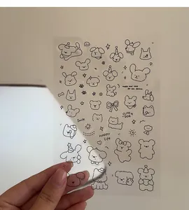Detailed view of transparent PVC sticker sheet with cute black line cartoon animal designs