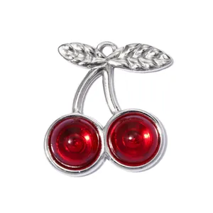Detail view of a 3D cherry pendant charm made of stainless steel with red stones