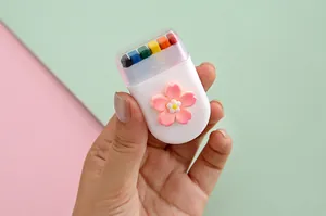 Close-up detail of 6-color rainbow face paint stick featuring pink cherry blossom decor