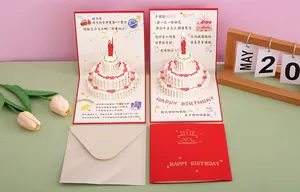Detailed view of a 3D pop-up birthday cake card with envelope and gift props.