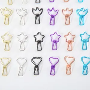 Close-up of assorted colorful shaped metal paper clips in star crown and heart designs