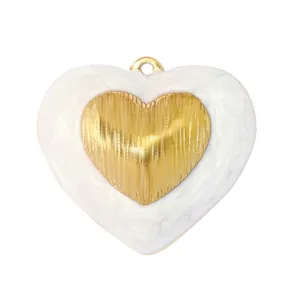 Detailed view of a vintage heart-shaped stainless steel pendant with pearlescent white inlay