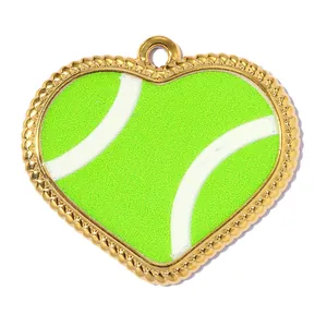 Macro detail of a heart-shaped tennis ball pendant with a beaded gold frame.