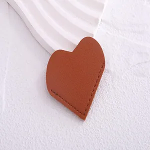 Detailed macro view of a brown PU leather heart bookmark showing premium edge stitching