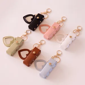Portable heart-shaped leather lipstick case with makeup mirror and golden keychain