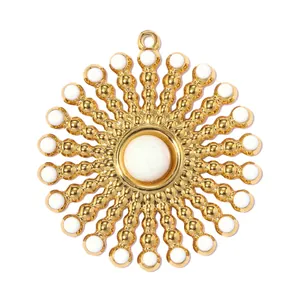 Close-up of a large golden stainless steel sun flower pendant with white bead accents.