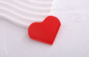 Detailed macro shot of a red heart-shaped PU leather bookmark with a stitched edge