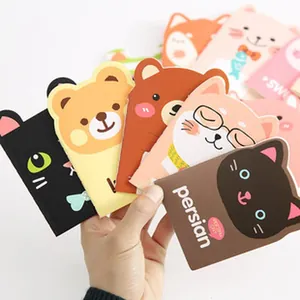 Close-up of hand holding various colorful cartoon animal shaped drawing templates for kids