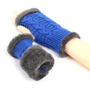 Detailed view of blue cable-knit arm warmers with grey faux fur lining and trim