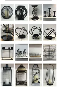 Collection of various vintage black iron candle holders and decorative lanterns.