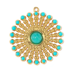Detailed macro view of a large stainless steel sunburst pendant with turquoise stones