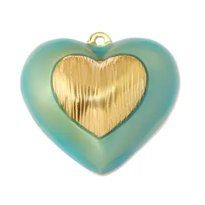 Macro view of vintage heart pendant with green resin and gold textured core