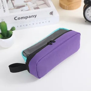 Detail showing the large capacity purple and teal oxford pencil case with handle.
