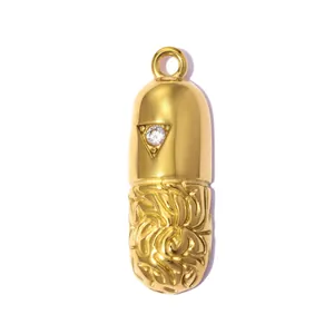 Macro detail of a gold stainless steel capsule pendant with sparkling zircon inlay