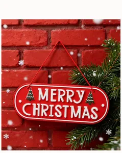 Detailed view of red embossed Merry Christmas metal sign with snowy brick background