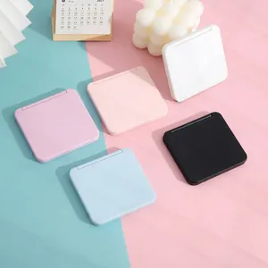 Detailed macro view of compact portable foldable makeup mirrors in multiple pastel colors