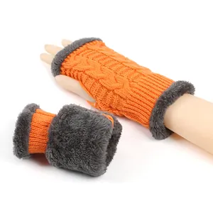 Thick orange knitted arm warmers with gray faux fur trim for winter warmth.