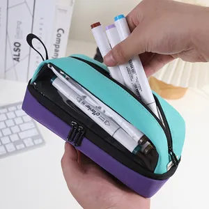 Detail view of a multi-layer purple and teal pencil case with transparent window.
