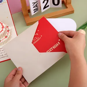Handmade 3D pop-up birthday card with cake design and cream envelope for special wishes.