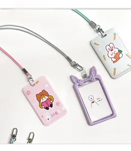 Close-up of cute cartoon ID card holders with lanyards in pastel pink, white and purple tones