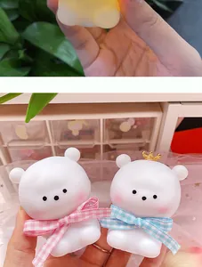 Close-up of cute white crown bear night lights featuring colorful plaid bowties