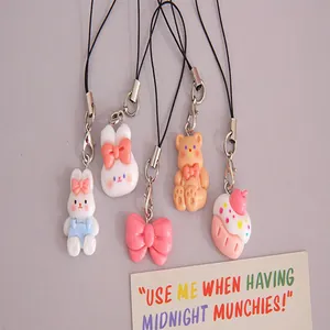 Detailed shot of cute resin charms featuring bunnies, bears, bows, and cupcake pendants