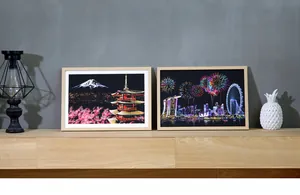 Detailed view of colorful city night landscape scratch art paintings in light wooden frames