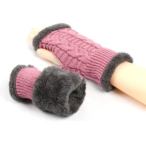 Detailed view of pink cable knit fingerless gloves with soft grey plush lining