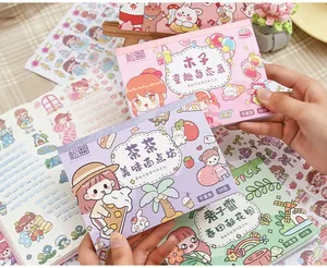 Close-up view of cute cartoon journaling sticker pads with various themes and characters