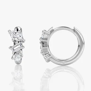 Close-up of silver-toned hoop earrings featuring three irregular moissanite stones