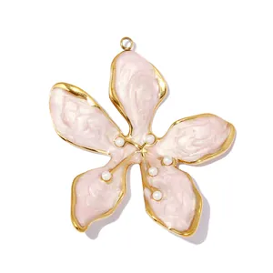Close-up of pink five-petal flower pendant with gold edges and pearl accents