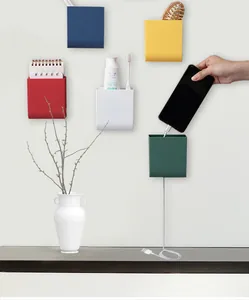 Multicolor wall-mounted storage boxes organizing stationery and phone charging usage