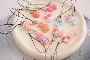 Close-up of various cute cartoon resin charms with rabbit and cake designs for accessories.
