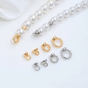 Close-up of gold and silver plated jewelry connectors and pearl necklace components