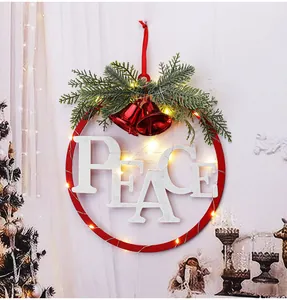 Close-up detail of festive Christmas iron wreath with PEACE letters and LED fairy lights