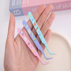 Detailed view of three colorful cartoon stainless steel tweezers for DIY crafts and journaling.