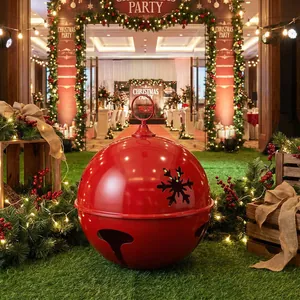 Large red metal Christmas bell ornament with snowflake cutouts for festive decor