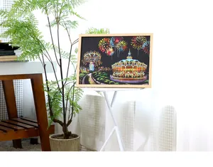 Creative DIY scratch art city night scene with carousel and fireworks in a wooden frame
