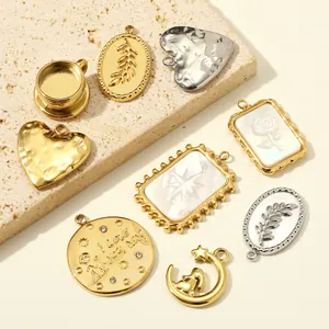 Detailed view of various stainless steel pendants with heart moon and shell patterns