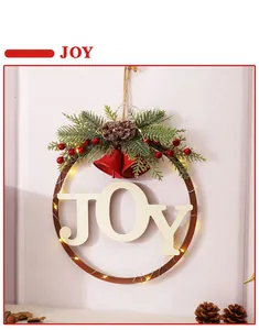 Detailed macro view of festive Christmas JOY door wreath with pine needles and LED lights