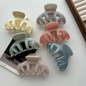 Set of six colorful matte pumpkin hair claw clips for thick hair shown in a group flat lay