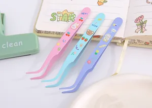Close-up of cute cartoon stainless steel curved tweezers for DIY scrapbooking