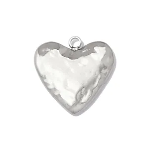 Close-up of a silver stainless steel heart pendant with hammered texture detail.