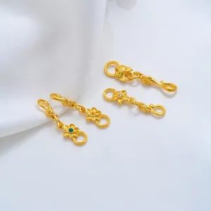 Detailed view of 24K gold plated flower and dragon motif jewelry connectors for DIY crafts