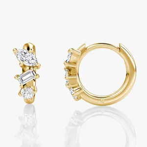 Detailed view of 14k gold moissanite huggie hoop earrings with three distinct stones